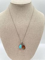 Full view of sterling chain with both pendants displayed on form