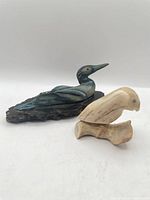 Wide shot showing both bird sculptures