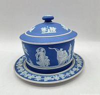 Assembled tub with lid on underplate showing relief decoration