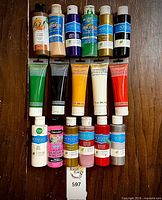 Front view of all 17 acrylic paint containers showing colours, brands, and usage level
