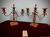 Both candelabras front view showing overall style and patina