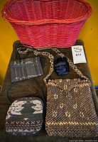 Overview showing pink wicker basket, four small bags and purses