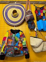 Overall view showing sombrero, patchwork jacket, woven bags, headbands and beige tote