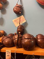 Group of coconut shell purses on shelf, price tag visible