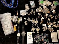 Overall view of assorted jewelry including necklaces, earrings, rings, wristwatches