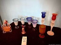 Front view of all nine items arranged, showing colours and forms