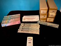 Lot overview showing stacked Patchouli packs, Beckwoman's Frankincense boxes and assorted cardboard cartons labeled for scents