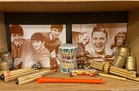 All instruments and prints displayed together on shelf