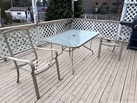 Full view of table and two chairs on deck