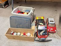 Group shot showing cooler, wooden box contents, RC cars and loose bumper