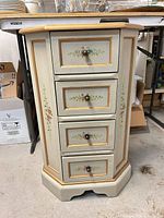 Full view of painted four-drawer wood cabinet