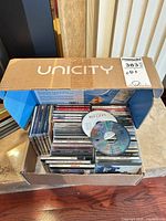 Box filled with numerous CD jewel cases, one Bee Gees disc on top