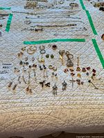 Entire lot laid out showing earrings, pins and small accessories
