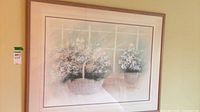 full view of framed floral basket print on wall
