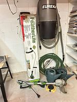Overall view showing boxed FeatherLite trimmer, Haussmann edger, hose and watering cans