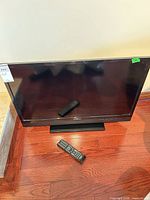 Front view of Insignia 32" LCD TV with remote