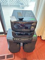 Full front view of stacked Kenwood XD-700 system with remote on top and both speakers below