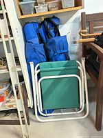 Lawn chair folded with two camp chairs in bags