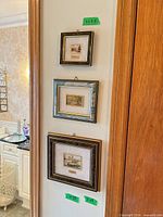Three vertically arranged small framed prints with size labels visible