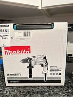 Front of Makita HP1631K drill box showing product image and specifications