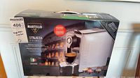 Front of boxed Martello Stilista Primeo espresso machine showing product image and specs