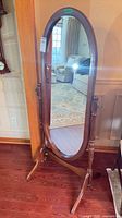Front view of wooden cheval mirror showing full frame and oval glass