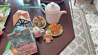 Group shot showing teapot, cookie jar, small house container and miniatures