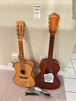 Both Framus guitars side by side with string pack visible