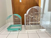 Both cages side by side showing size difference and overall condition