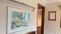Colour still-life print in gold frame mounted on wall