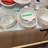 Group shot of Pyrex round dish, CorningWare square, rectangular, oval dishes, and white creamer