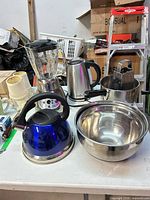 Group shot showing tea kettle, blender, electric kettle, saucepan with grater, mixing bowl set, ceramic mugs