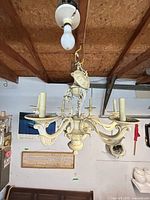 Full view hanging chandelier showing six arms and finish