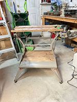 Full view of folded-out Workmate showing wooden top and metal frame