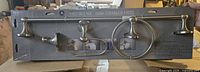 Front view of sealed 4-piece Plaza bathroom hardware set showing all items in package