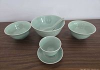 Full set arranged: large bowl, 2 small bowls, spoon, teacup with saucer