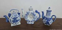 Group shot of three blue and white porcelain teapots