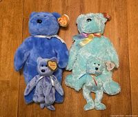 Four Ty bears—two large, two mini—arranged on floor