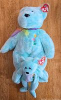 Front view of both Ariel bears showing size difference, ribbons, embroidery, swing tags