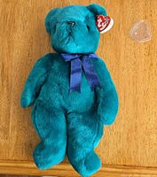 Full view of teal TY Teddy Beanie Baby with ribbon and swing tag