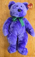 Front view of purple Ty Employee Bear with green ribbon