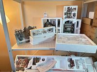 Lot overview on shelving showing multiple Department 56 Styrofoam cartons with village pieces visible