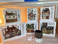 All six porcelain buildings in open Styrofoam packaging with rolled Cobblestone Road