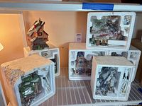 Six styrofoam packs plus one assembled building on shelf