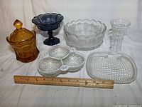 All six glass pieces arranged with ruler for scale