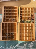Four divided ornament storage trays with some ornaments inside