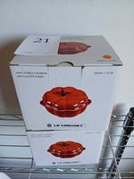 Two Le Creuset pumpkin cocotte boxes stacked
