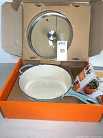 Pan and lid inside original orange Le Creuset box