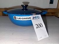 Pot with lid showing brand label and blue exterior
