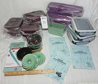Group shot showing all bakeware, glass pans, storage containers, cleaning tool and Good Housekeeping inserts